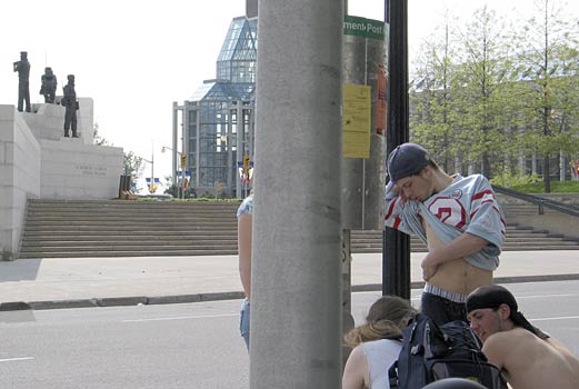 view of  the peacekeeping monument, the national gallery and some young men of an age typical of recruits